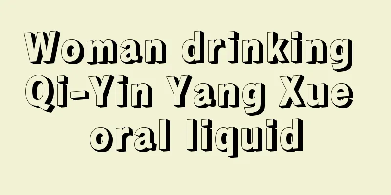 Woman drinking Qi-Yin Yang Xue oral liquid