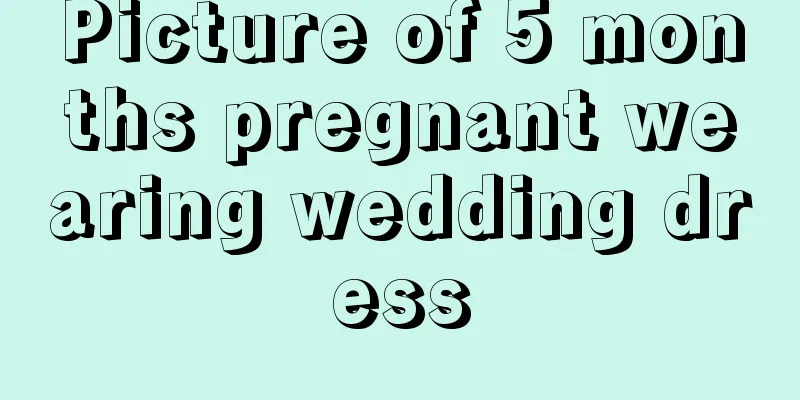 Picture of 5 months pregnant wearing wedding dress