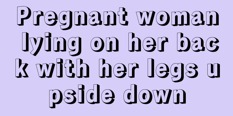 Pregnant woman lying on her back with her legs upside down