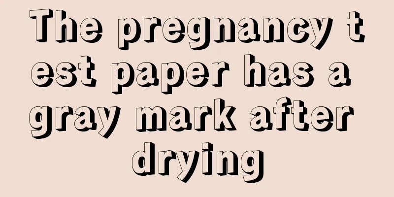 The pregnancy test paper has a gray mark after drying