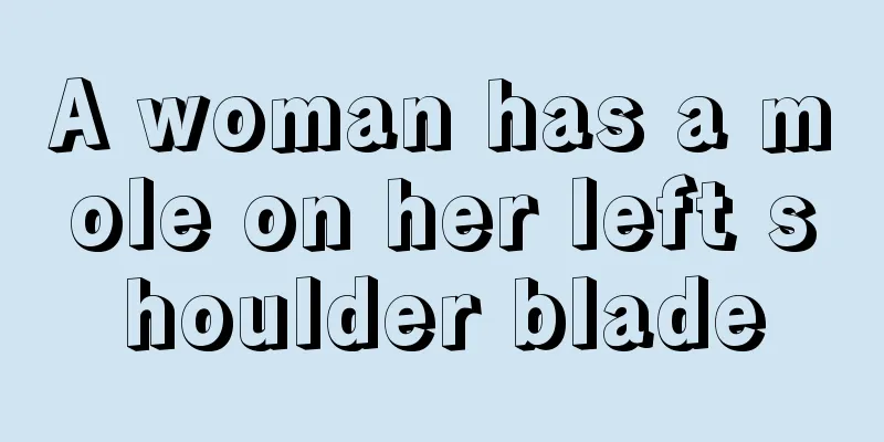 A woman has a mole on her left shoulder blade