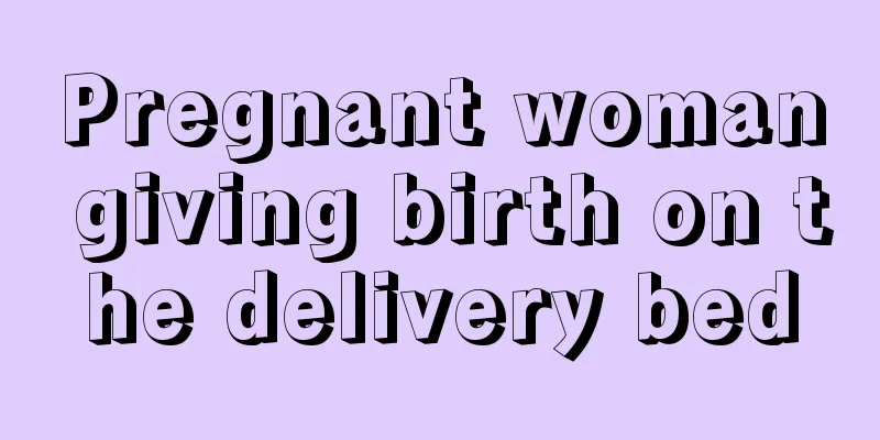 Pregnant woman giving birth on the delivery bed