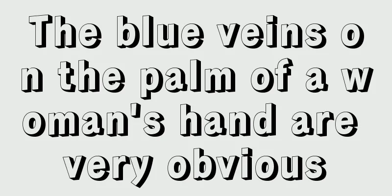 The blue veins on the palm of a woman's hand are very obvious