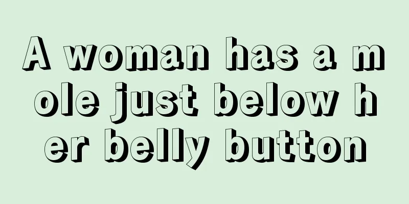 A woman has a mole just below her belly button