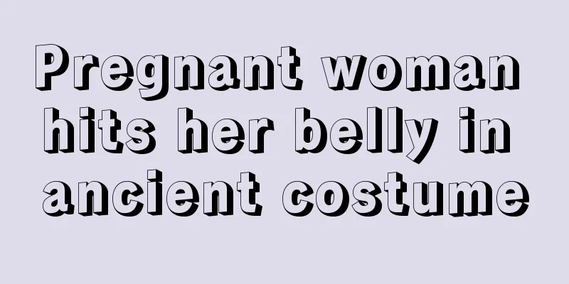 Pregnant woman hits her belly in ancient costume