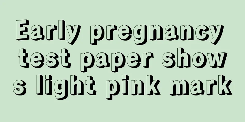 Early pregnancy test paper shows light pink mark