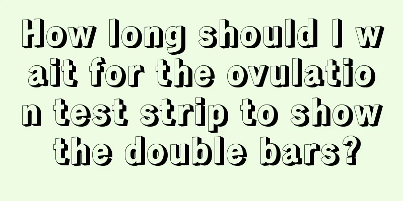 How long should I wait for the ovulation test strip to show the double bars?