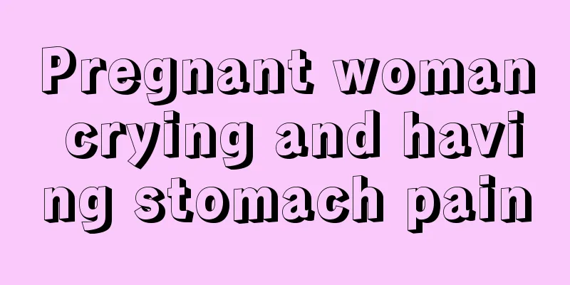 Pregnant woman crying and having stomach pain