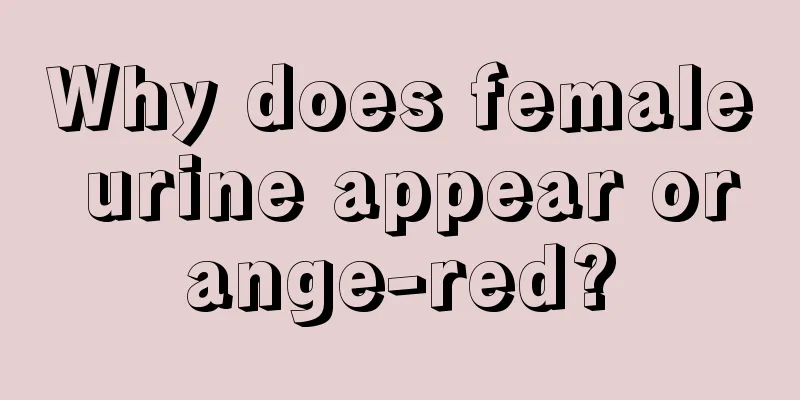 Why does female urine appear orange-red?