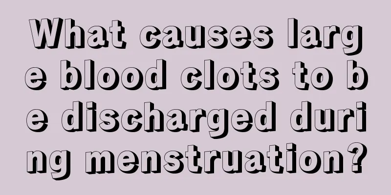 What causes large blood clots to be discharged during menstruation?