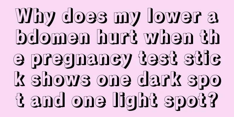 Why does my lower abdomen hurt when the pregnancy test stick shows one dark spot and one light spot?