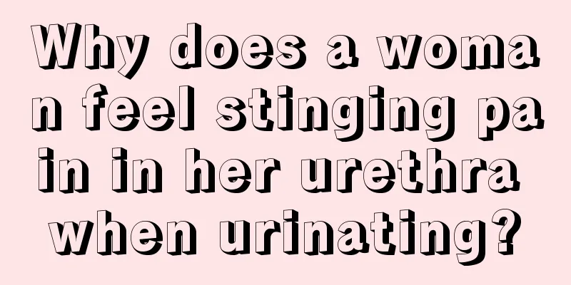 Why does a woman feel stinging pain in her urethra when urinating?