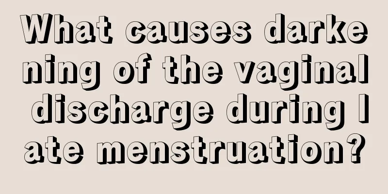 What causes darkening of the vaginal discharge during late menstruation?