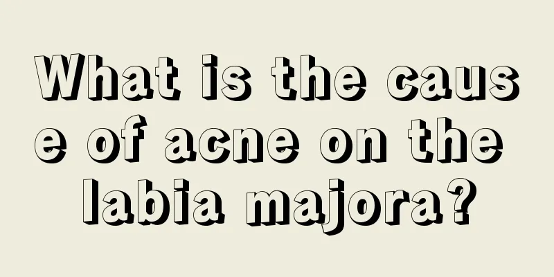 What is the cause of acne on the labia majora?