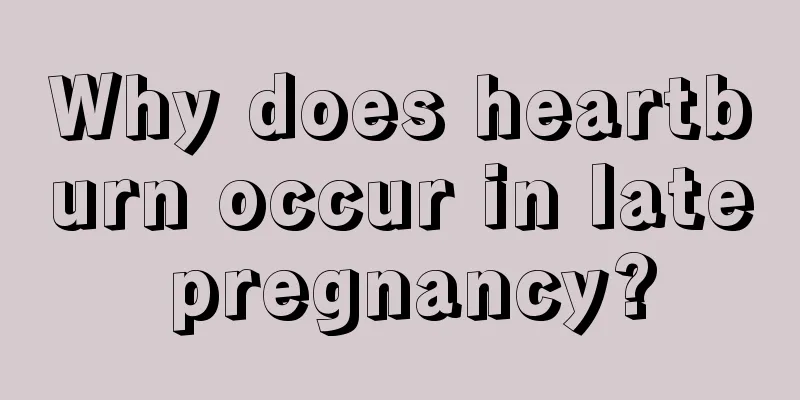 Why does heartburn occur in late pregnancy?